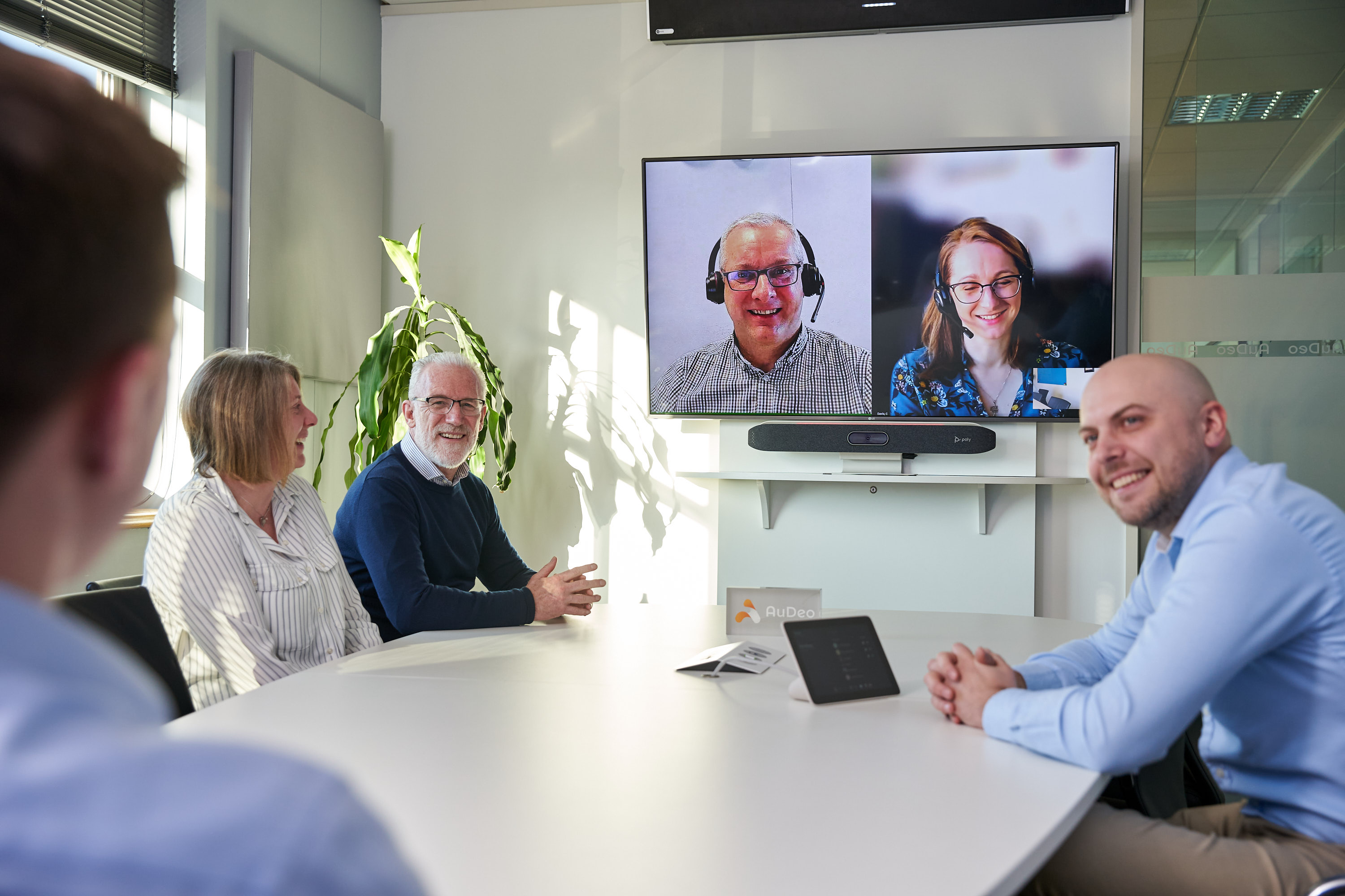 People Meeting in Boardroom Using Video Conferencing